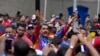 ARCHIVO - El presidente de Venezuela, Nicolás Maduro, saluda a jóvenes partidarios en una marcha contra sanciones estadounidenses en Caracas, Venezuela, el 17 de mayo de 2024.