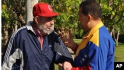 Former Cuban leader Fidel Castro and Venezuela's President Hugo Chavez (R) speak in Havana in this June 28, 2011 handout photo. Supporters of Chavez hailed the release of new footage of the socialist leader as evidence he was recovering from surgery in Cu