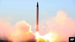 This picture released by the official website of the Iranian Defense Ministry on Sunday, Oct. 11, 2015, claims to show the launching of an Emad long-range ballistic surface-to-surface missile in an undisclosed location. Iran successfully test fired a new 