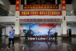 FILE - An image of Chinese President Xi Jinping is seen inside a building at the Wenchang Space Launch Center, in Hainan province, China, Nov. 23, 2020.