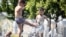 Children play in a fountain during a midday heat in central Moscow on July 3, 2024.