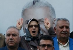 Backdropped by a poster of Binali Yildirim, former Prime Minister and candidate for Istanbul of the ruling Justice and Development Party's (AKP), people chant Islamic slogans during a protest in Istanbul, March 11, 2019.