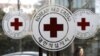 A pedestrian moves past the logos of the Korea Red Cross at its headquarters in Seoul, South Korea, Wednesday, Feb. 9, 2011. South Korea agreed Wednesday to hold talks with North Korea on reuniting families separated by war, as military officers from both