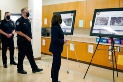 Vice President Kamala Harris looks at photos as she visits the Paso del Norte (PDN) Port of Entry in El Paso, Texas, June 25, 2021.