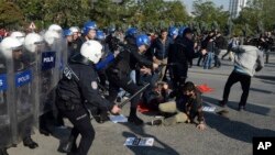 Riot police clash with protesters as they push back hundreds of activists trying to reach the site of last year's twin suicide bombings to commemorate more than a hundred victims of an attack blamed on Islamic State militants, outside the main train station in the capital Ankara, Turkey, Oct. 10, 2016.