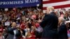 Singer Lee Greenwood points at President Donald Trump and Vice President Mike Pence as he sings during a campaign rally, Sunday, Nov. 4, 2018, in Chattanooga, Tenn.