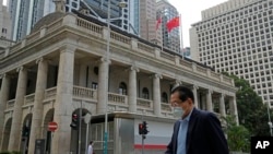 FILE - A pedestrian passes the Court of Final Appeal in Hong Kong, on March 30, 2022. 