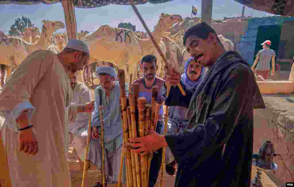 Despite the new controls, Abdul-Muhsin, who sells batons used to beat the camels in order to drive and control them, still does brisk business in the days before Eid. (VOA/H. Elrasam)