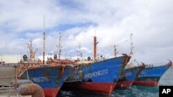 FILE - Boats are docked at the Majuro port in the Marshall Islands, Feb. 1, 2018. The islands this week Islands this week suspended all incoming air travel to guard against the transfer of the coronavirus.