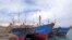 FILE - Boats are docked at the Majuro port in the Marshall Islands, Feb. 1, 2018. The islands this week Islands this week suspended all incoming air travel to guard against the transfer of the coronavirus.