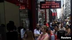 People line up outside a currency exchange store in Buenos Aires' financial district, in Argentina, Oct. 25, 2019.
