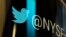 FILE - The Twitter logo is seen on a phone post on the floor of the New York Stock Exchange, Oct. 27, 2016.