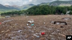 Flood debris from Hurricane Helene floats by in Rutherford County, North Carolina, Sept. 29, 2024. 