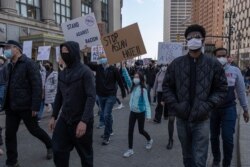 People march during a ‘Stop Asian Hate’ rally in downtown Detroit, Michigan on March 27,2021, as part of a nation wide protest in solidarity against hate crimes directed towards Asian Americans.