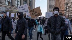 FILE - People march during a ‘Stop Asian Hate’ rally in downtown Detroit, Michigan on March 27,2021, as part of a nation wide protest in solidarity against hate crimes directed towards Asian Americans.