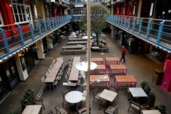 FILE - An empty outdoor eating area is seen as the spread of the coronavirus disease continues, in London, Britain, March 21, 2020.