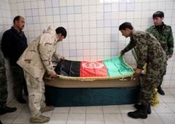 Afghan National Army soldiers drape the flag of Afghanistan on the coffin of Japanese Dr. Tetsu Nakamura, at a hospital in Kabul, Afghanistan, Dec. 6, 2019.
