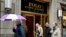 FILE - People pass the Polo Ralph Lauren store on Fifth Avenue in New York, April 4, 2017.
