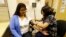 In this photo taken Thursday, April 11, 2013 Liz DeRouen, 49, left, gets her blood pressure checked by medical assistant Jacklyn Stra, right, at the Sonoma County Indian Health Project in Santa Rosa, Calif. The Indian Health Service, whose funding could b