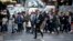 FILE - Pedestrians cross a road in Sydney, Australia, Sept. 6, 2017. Australia's population has reached 25 million for the first time, according to official estimates. 