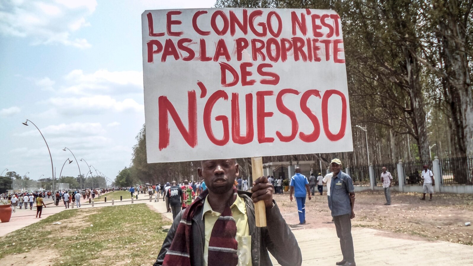 FILE - A man holds a placard reading, "Congo is not the property of Nguesso," during a demonstration against President Denis Sassou Nguesso in Brazzaville, Republic of Congo, Sept. 27, 2015.