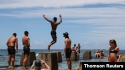 Beachgoers enjoy a summer day at Coogee Beach in Sydney