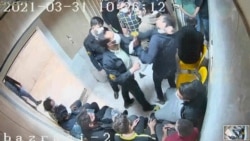In this frame grab taken from video shared with AP by 'The Justice of Ali,' a guard beats a prisoner, at Evin prison in Tehran, Iran. (The Justice of Ali via AP)