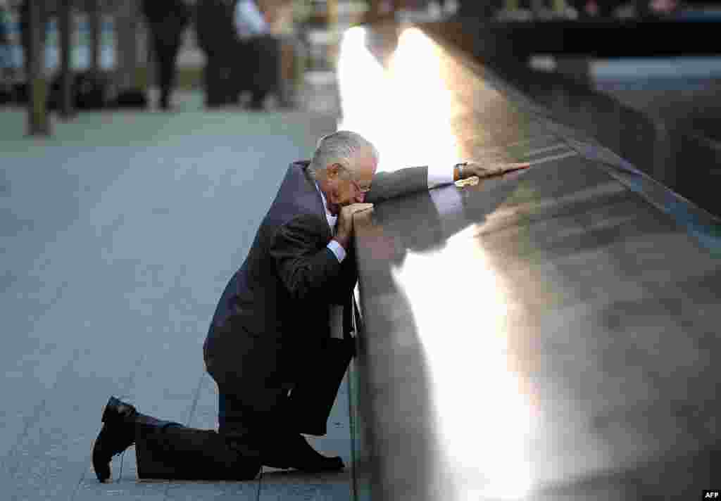 Robert Peraza pauses at his son's name at the North Pool of the 9/11 Memorial during tenth anniversary ceremonies at the site of the World Trade Center in New York, September 11, 2011. (Reuters)