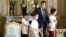 French President Emmanuel Macron holds the hand of a boy with autism as they visit the Elysee Palace before the launching of a program to enhance the diagnosis and treatment of autism, in Paris, July 6, 2017. Macron will unveil a plan to help children with autism.