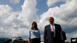 President Donald Trump, with first lady Melania Trump, speaks to the media about the recent mass shootings in El Paso, Texas, and Dayton, Ohio, before boarding Air Force One in Morristown, New Jersey, Aug. 4, 2019, to return to Washington.