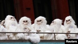 FILE - Actors dressed as a yeti ride a tour bus in Manhattan, New York City, Oct. 4, 2016.