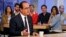 French President Francois Hollande gestures as he takes part in a live television program at Canal+ headquarters in Paris, April 19, 2015.