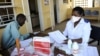 A patient waits for his pills as he meets with a nurse at Nhlangano health center in Swaziland, Oct. 28, 2009. 