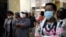FILE - Customers wear masks to protect against the coronavirus while queuing at a supermarket in Gaborone, Botswana, March 31, 2020, during the early weeks of the country's COVID-19 restrictions.