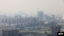 A general view taken from western Tehran shows a blanket of brown-white smog covering the city as heavy pollution hit the Iranian capital, Nov. 13, 2019.