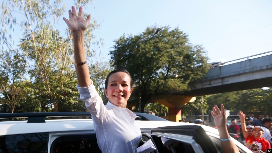 Philippine presidential candidate Sen. Grace Poe waves to supporters after addressing a rally to mark International Women's Day Tuesday, March 8, 2016 .