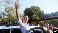 Philippine presidential candidate Sen. Grace Poe waves to supporters after addressing a rally to mark International Women's Day Tuesday, March 8, 2016 .