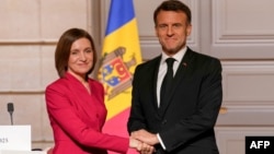 France's President Emmanuel Macron, right, and his Moldovan counterpart Maia Sandu shake hands following a joint press conference and their meeting at the Elysee palace in Paris, on March 10, 2025.