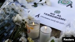 A sign that reads "No to terrorism, Colombia is in mourning" is seen in front of the scene where a car bomb exploded, in Bogota, Colombia, Jan. 18, 2019.