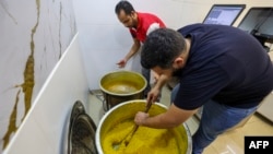 Samir Makari stirs a pot as he makes mufataka, a traditional Beiruti sweet, at his shop in the Lebanese capital on Aug. 29, 2024.