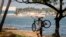 A cyclist walks along the seafront in Santo Domingo on July 29, 2020. Dominican Republic's Emergency Operation Center increased the alert level from yellow to red ahead Tropical Storm Isaias.
