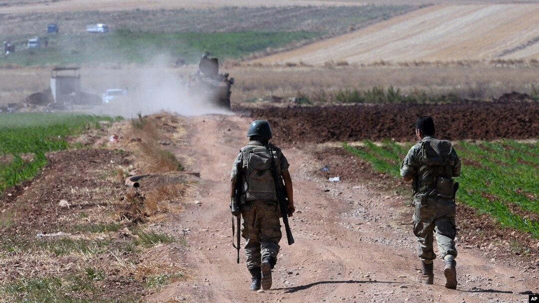 FILE - Turkish soldiers patrol near the border with Syria in southeastern Turkey, July 24, 2015.
