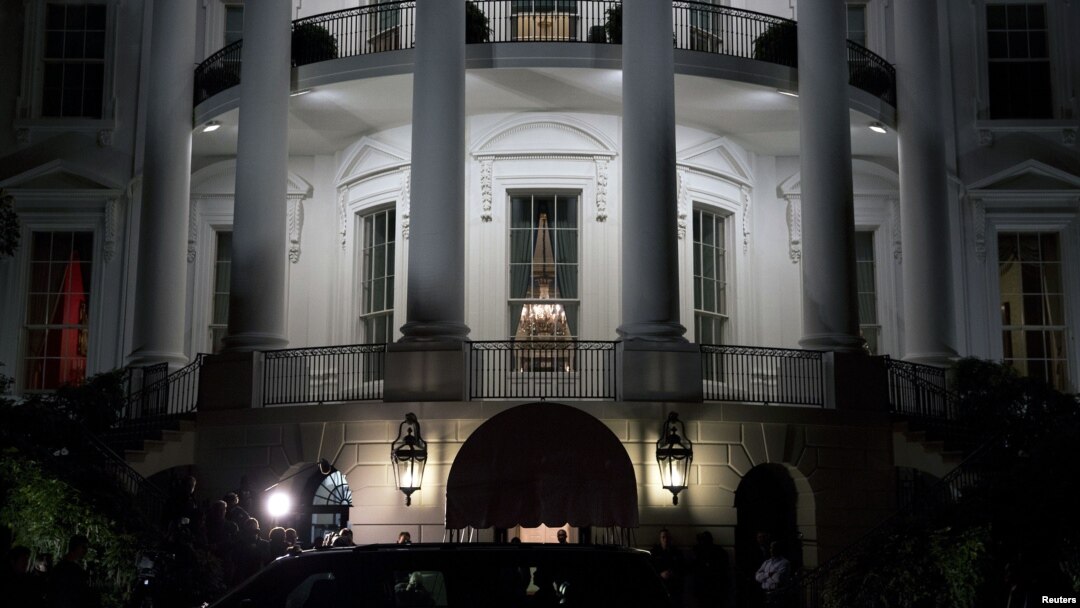 U.S. President Barack Obama (silhouetted in car window) and his family return after his re-election, to the White House in Washington, November 7, 2012. 