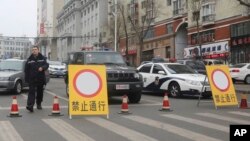 FILE - Police vehicles block a street of the prefectural seat of Shuangyashan after several days of protest by miners over late wages in northeastern China's Heilongjiang province. Frustration among miners over unpaid wages has swelled to the brink of unrest in the province in China’s far northeast. (AP Photo/Gerry Shih) Police vehicles block a street of the prefectural seat of Shuangyashan after several days of protest by miners over late wages in northeastern China's Heilongjiang province. Frustration among miners over unpaid wages has swelled to the brink of unrest in the province in China’s far northeast.