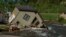FILE - A house sits in Rock Creek after floodwaters washed away a road and a bridge in Red Lodge, Montana, June 15, 2022. The state attorney general is appealing a ruling that said state agencies aren't doing enough to protect young plaintiffs from harm caused by global warming.