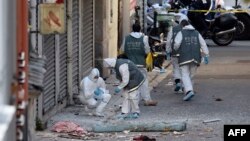 French forensics police search for evidence outside a building in Saint-Denis, where special forces raided an appartment, hunting those behind the attacks that claimed 129 lives in Paris last week, Nov. 18, 2015.