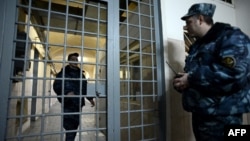 FILE - Guards stand in a prison lobby in Moscow, Russia, Dec. 4, 2013.