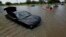 Domingo Molina paddles with his granddaughters down a flooded street in Houston, May 26, 2015. 