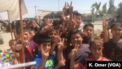 Children raise their hands, doing the “V Sign,' Intisar neighborhood (left side of Mosul), July 19, 2017.