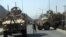 A US soldier directs his colleagues at the site an Oct. 11 bomb attack that targeted several armored vehicles belonging to forces attached to the NATO Resolute Support Mission, in downtown of Kabul.